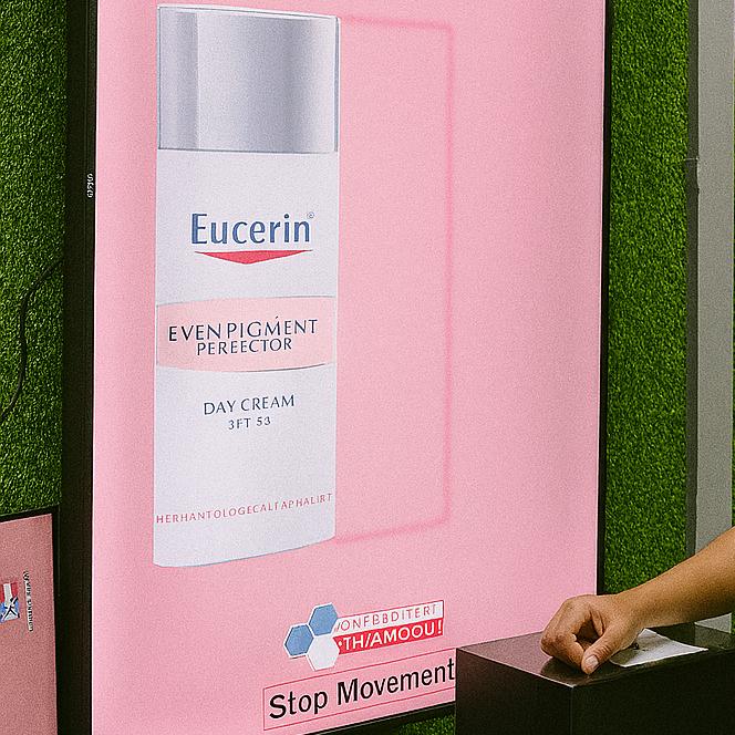 Guests playing Freeze the Frame interactive game at a corporate event in Dubai, focusing on screen visuals and pressing the button to stop the image at the perfect moment.